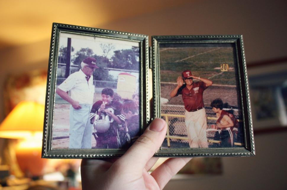 Free Image of Person Holding Up Picture of Baseball Player 