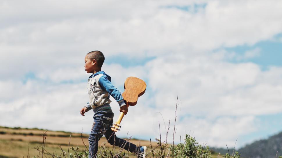 Free Image of Young Boy Running With Paddle 