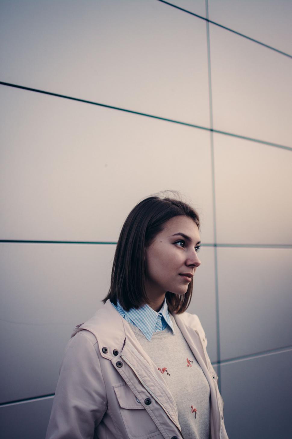 Free Image of Woman Standing in Front of Wall 