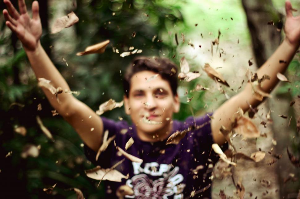 Free Image of Man Throwing Leaves in the Air 