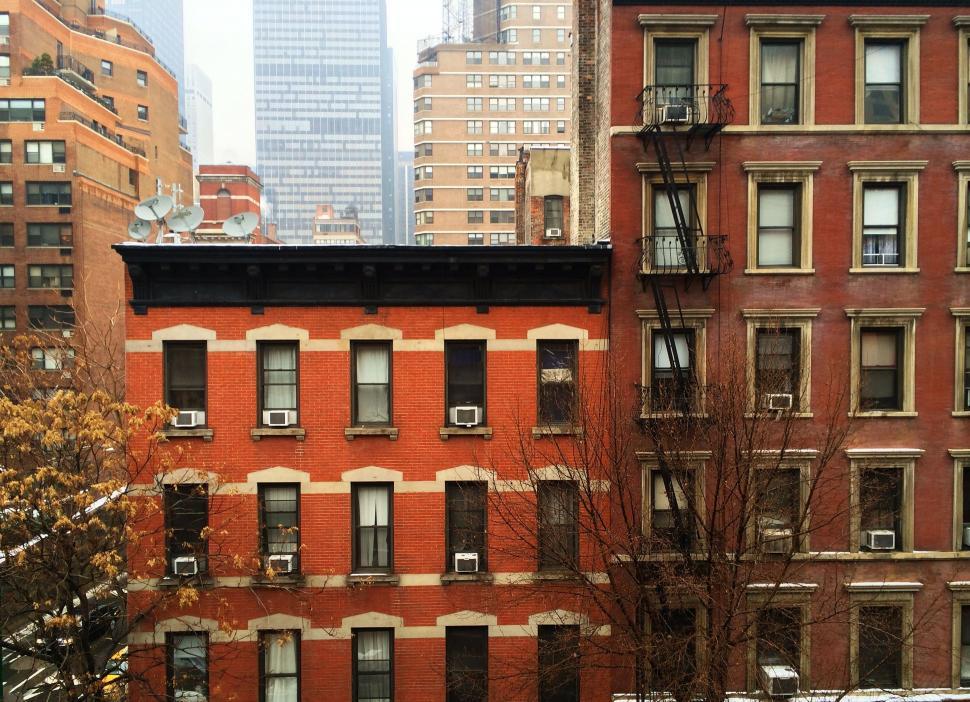 Free Image of Red Building With Many Windows in Urban Setting 