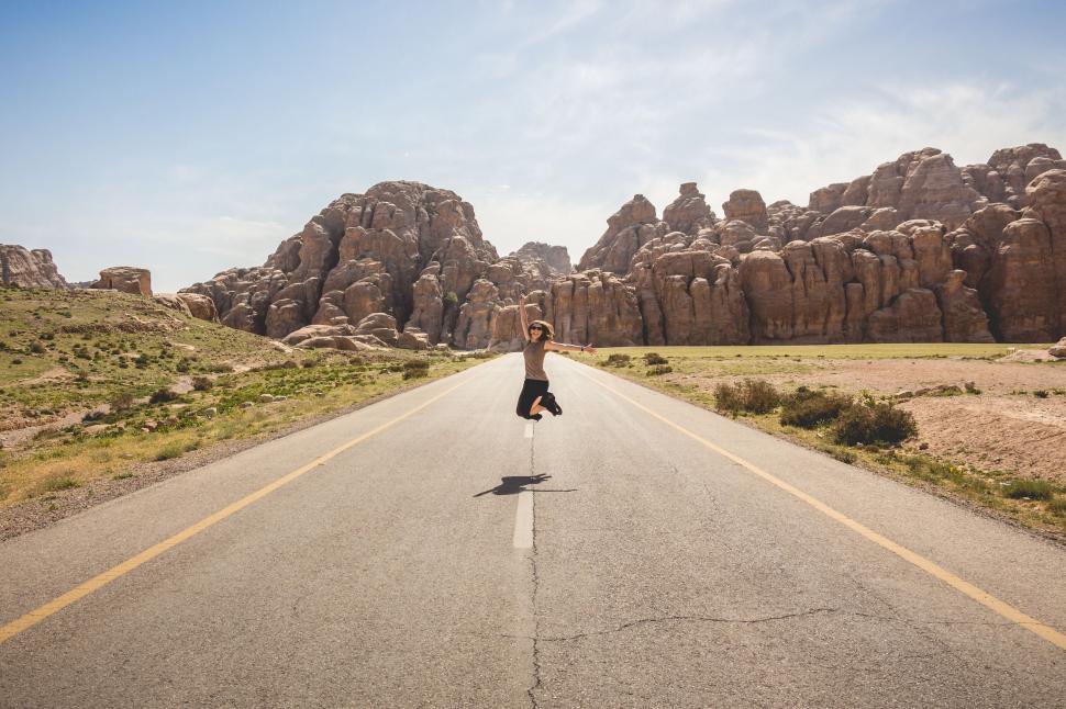 Free Image of Man Riding Skateboard Down Middle of Road 