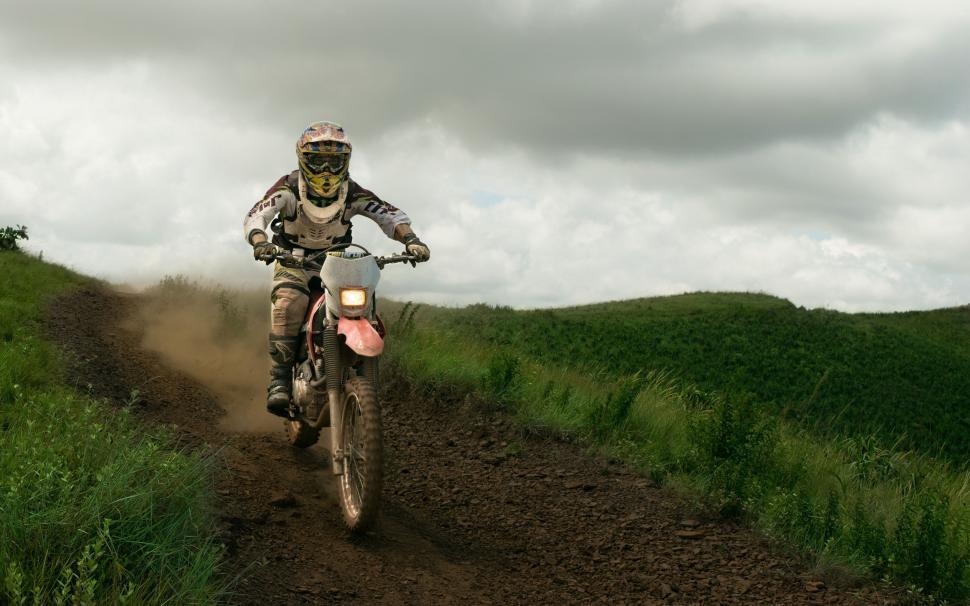 Free Image of Man Riding Dirt Bike Down Dirt Road 