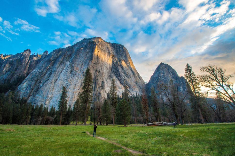 Free Image of Person Standing in Field in Front of Mountain 