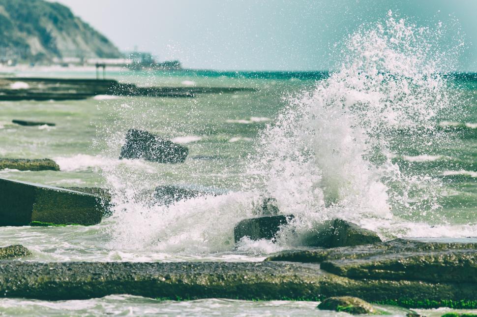 Free Image of Wave Crashing Into Rocks on Beach 