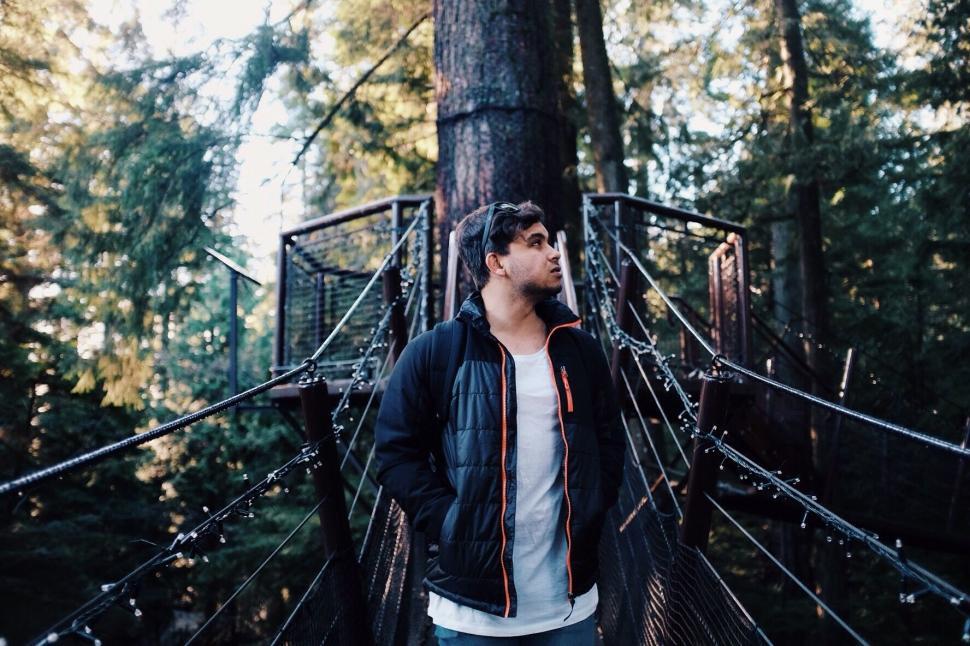 Free Image of Man Standing on Bridge in Woods 