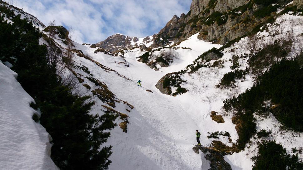 Free Image of Man Skiing Down Snow Covered Slope 