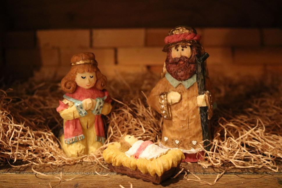 Free Image of Couple of Figurines Sitting on Top of a Pile of Hay 
