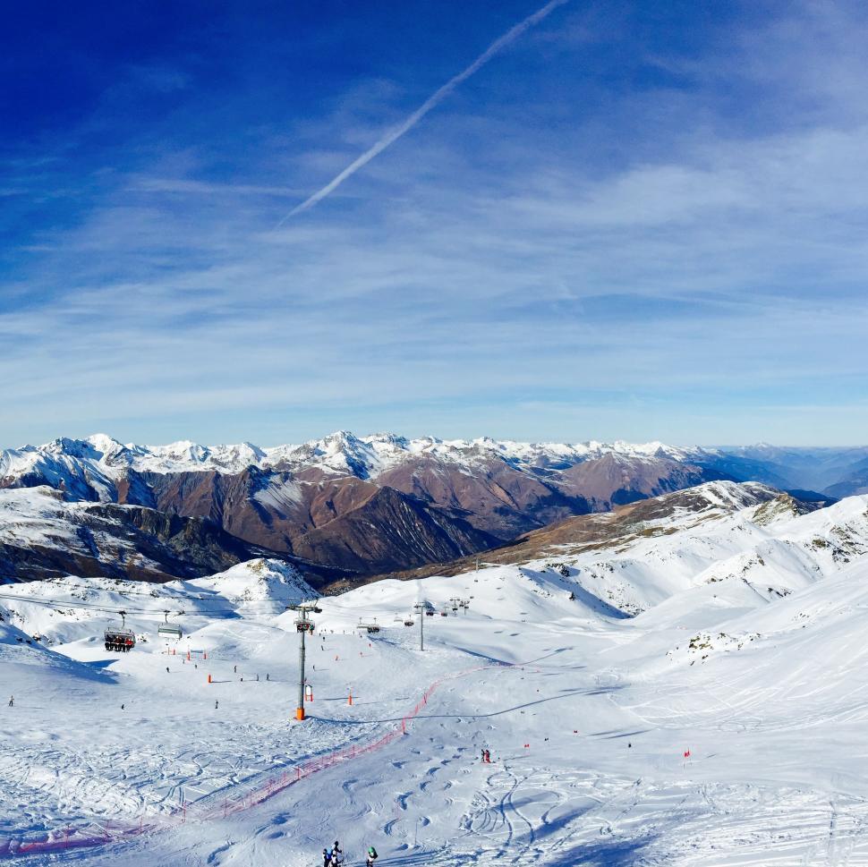 Free Image of Snowy Mountain With Distant Ski Lift 