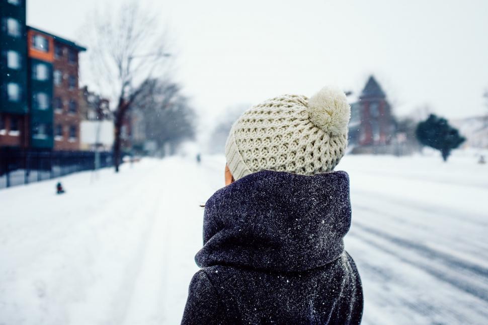 Free Image of Person Walking Down a Snow Covered Street 