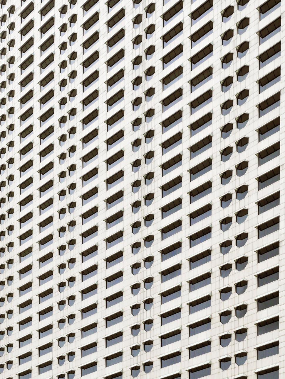 Free Image of Tall White Building With Lots of Windows 