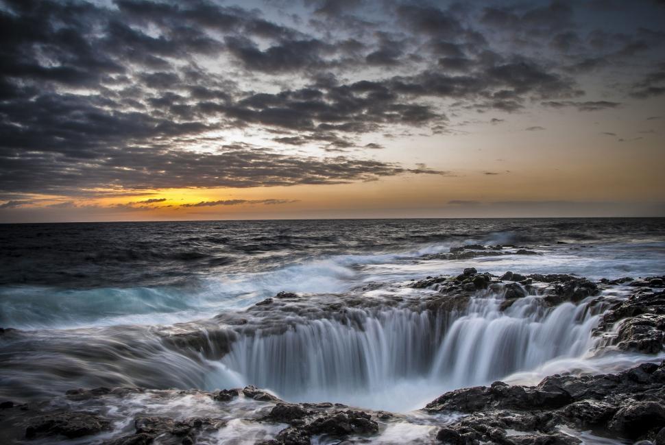 Free Image of Rocky Shoreline Surrounding Large Water Body 