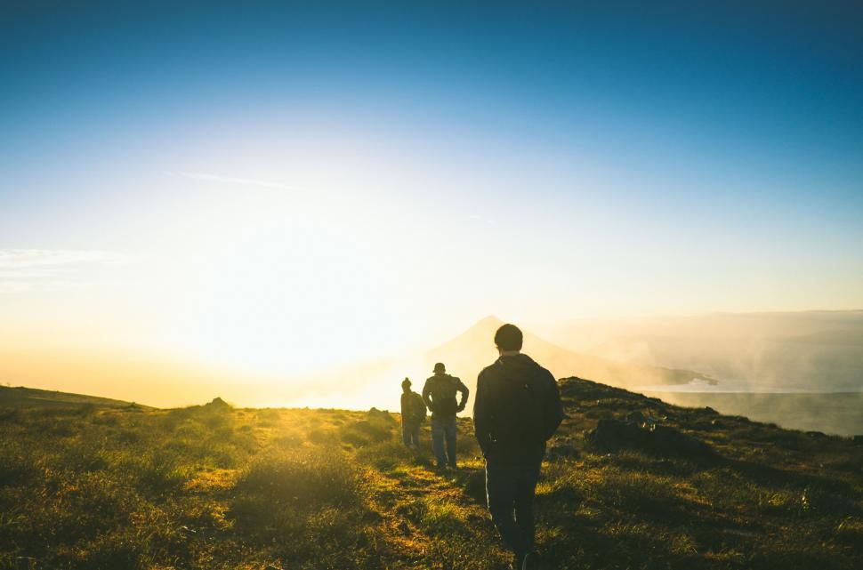 Free Image of Group of People Standing on Top of Lush Green Hillside 