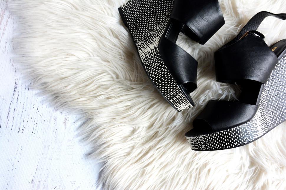 Free Image of Black High Heeled Shoes on White Rug 
