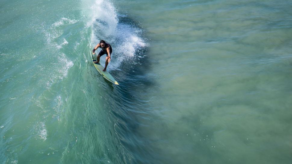 Free Image of Man Riding Wave on Surfboard 