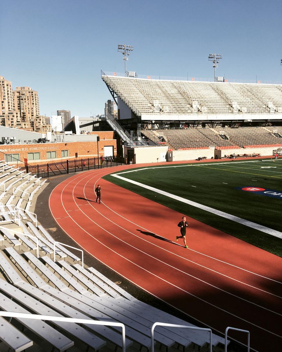 Free Image of Man Running on Track in Stadium 