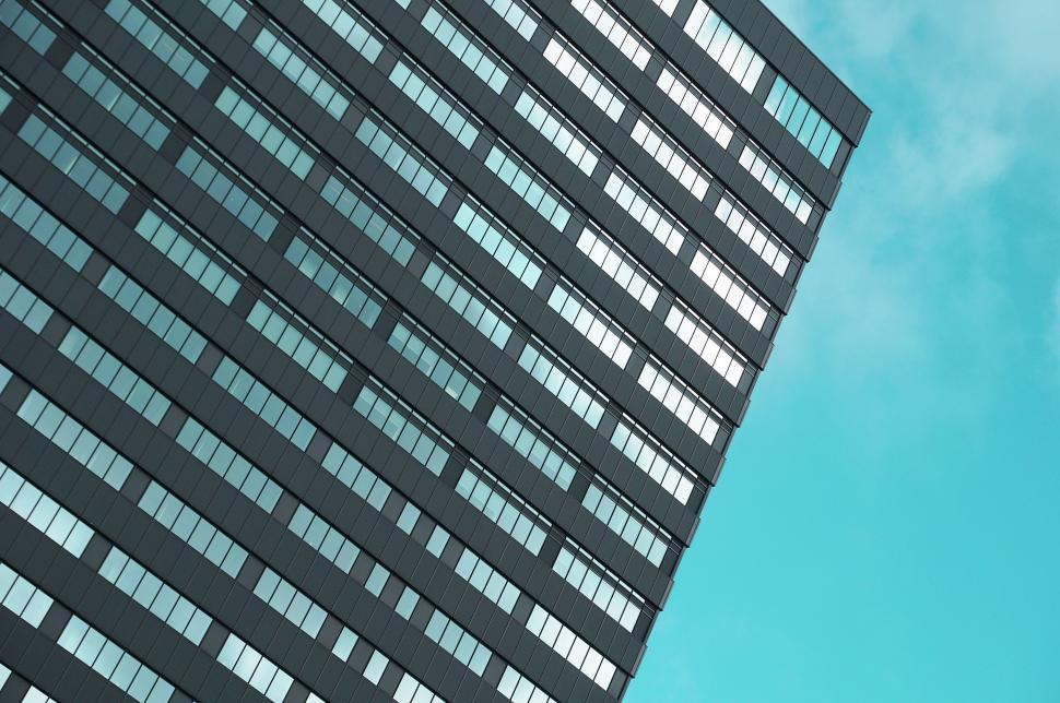 Free Image of Airplane Flying Over Tall Building 