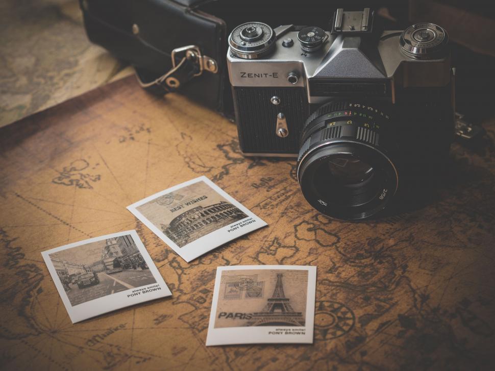 Free Image of Camera and Old Photos on Table 