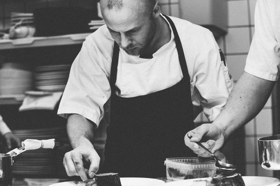 Free Image of Two Men Cooking Together in a Kitchen 