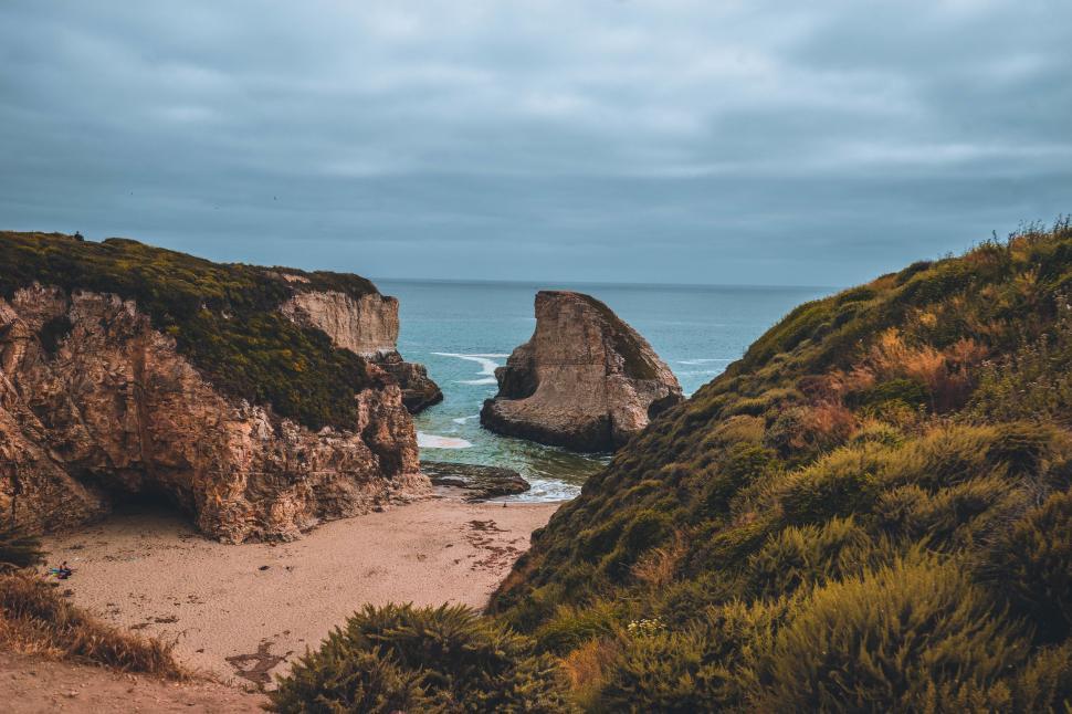 Free Image of Sandy Beach With Rock Formation 