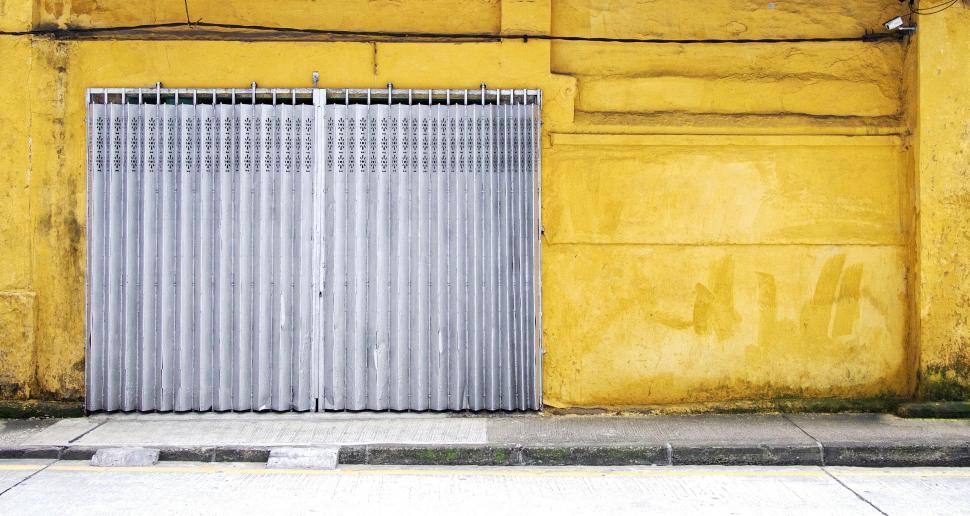 Free Image of Closed Yellow Building With Fire Hydrant 