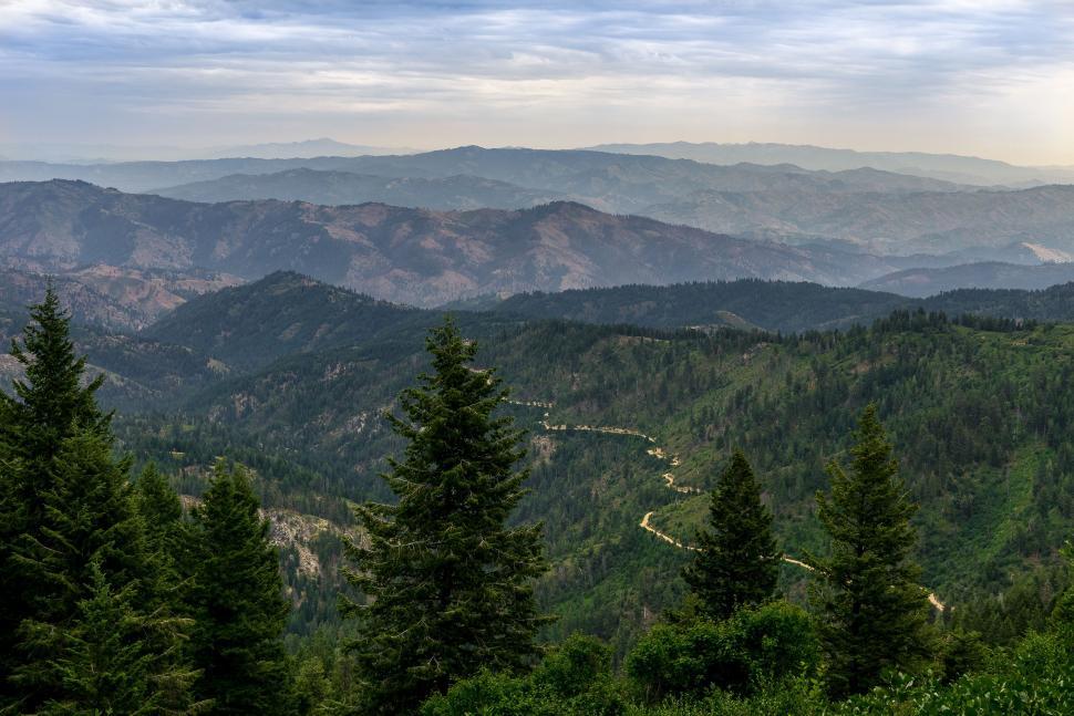 Free Image of Majestic Mountain Range With Trees in Foreground 