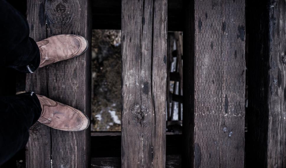 Free Image of Person Standing in Front of Wooden Wall 