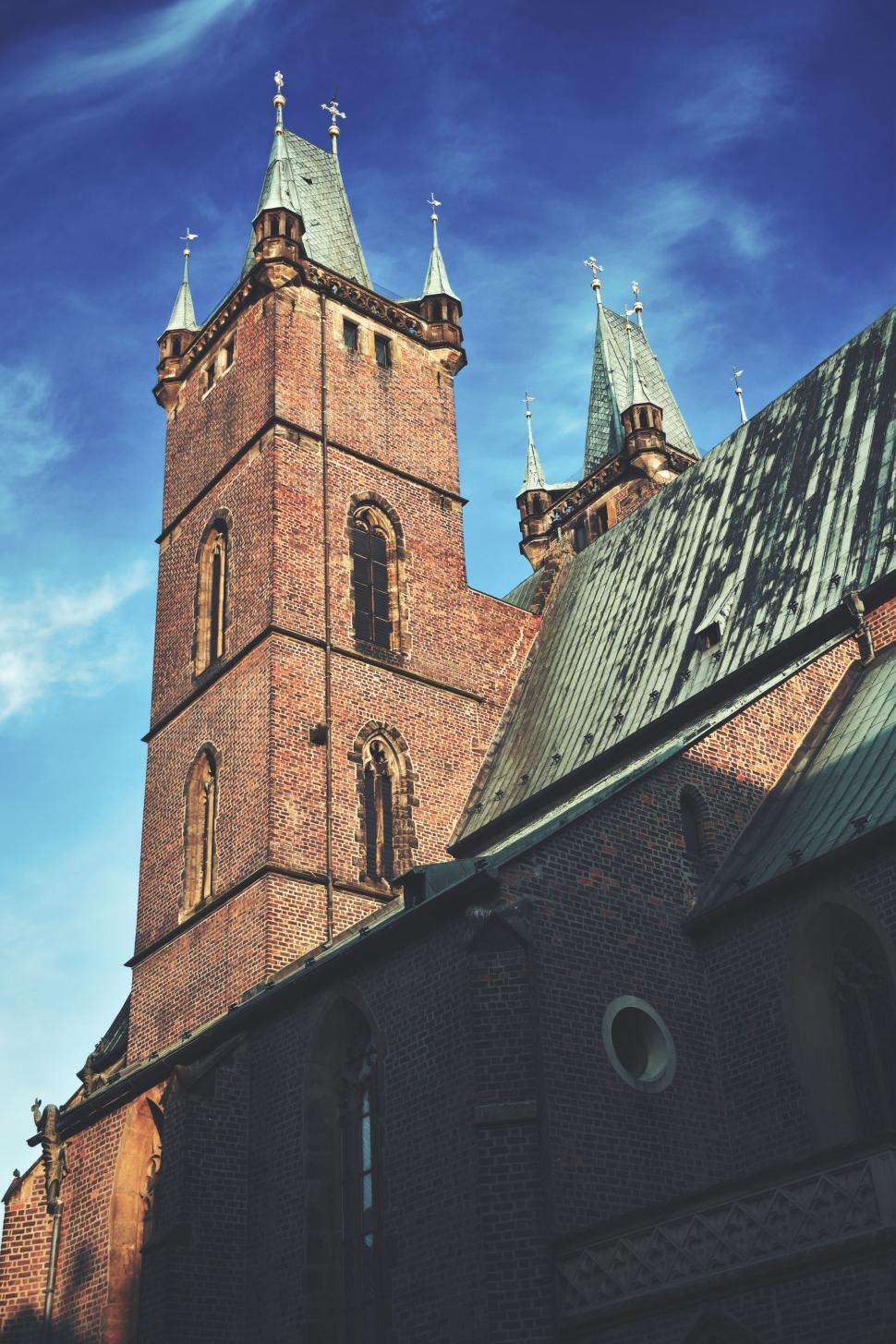 Free Image of Tall Brick Building With Clock on Side 