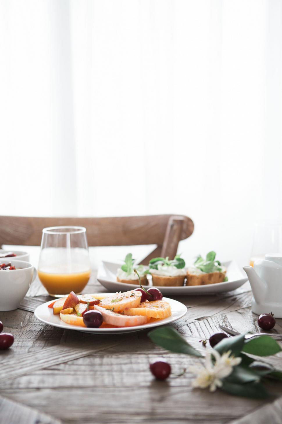 Free Image of Wooden Table Set With Plates of Food 