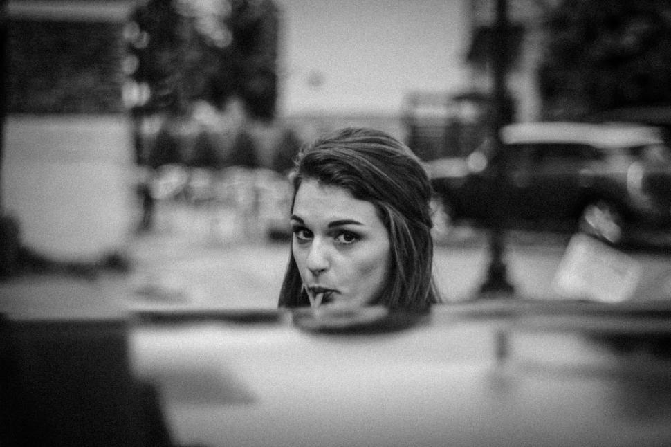 Free Image of Woman Looking in Mirror 