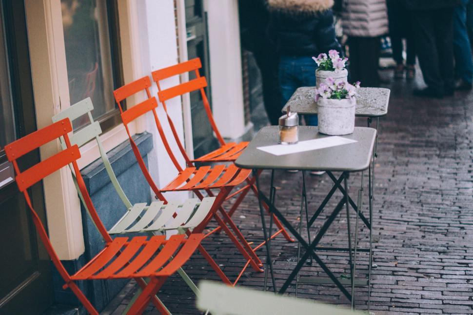 Free Image of Two Orange Chairs on Sidewalk 