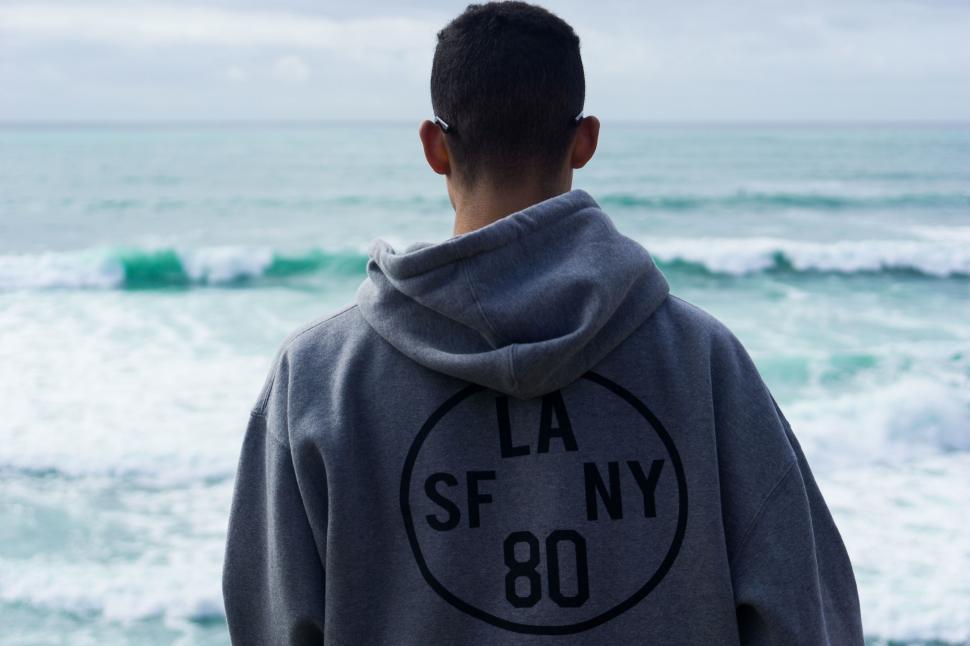 Free Image of Man Standing by Body of Water 