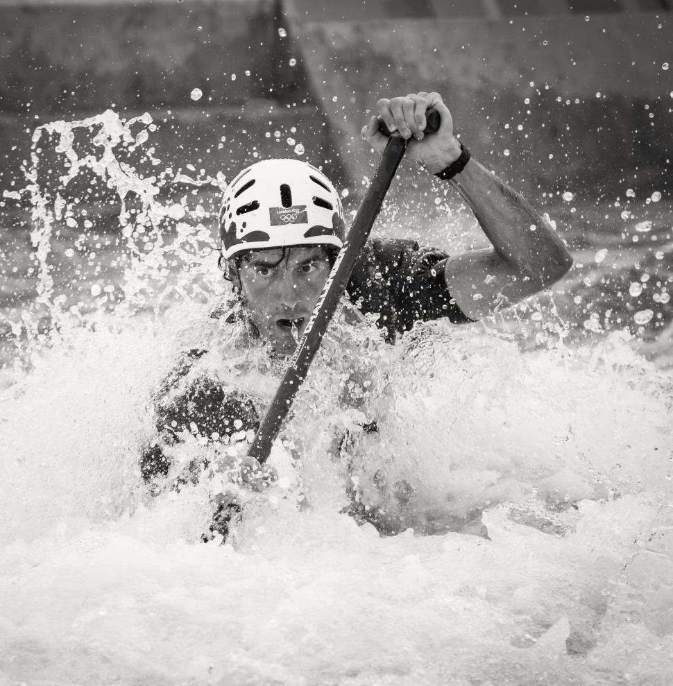 Free Image of Man Riding Paddle Boat on River 