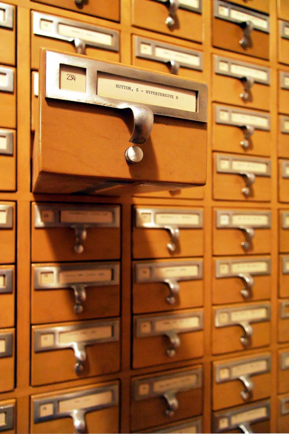 Free Image of Wall Full of Filing Cabinets Filled With Drawers 