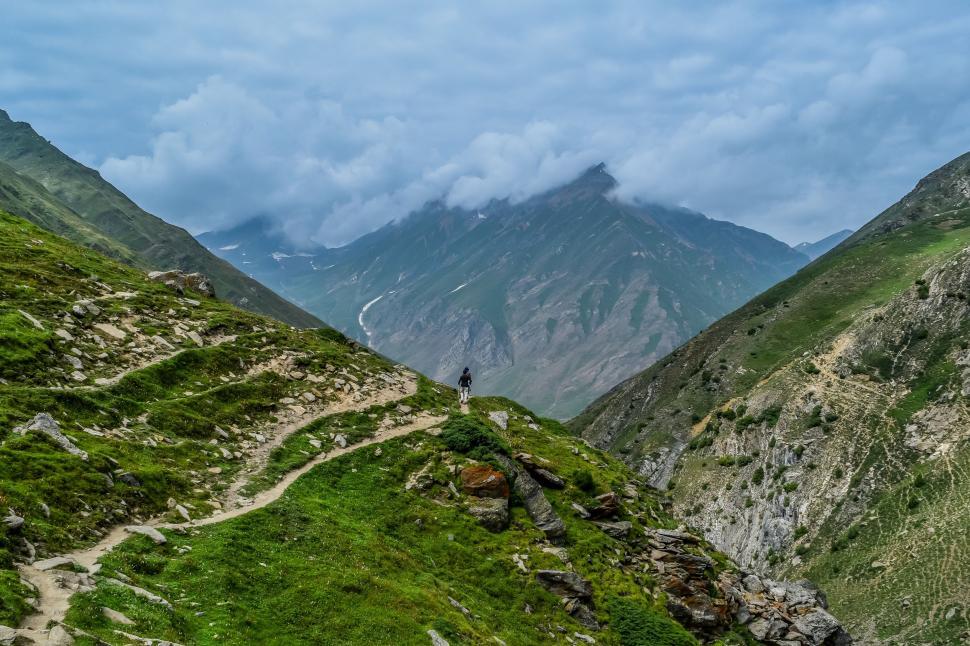 Free Image of Hiker Walking Up Mountain Trail 