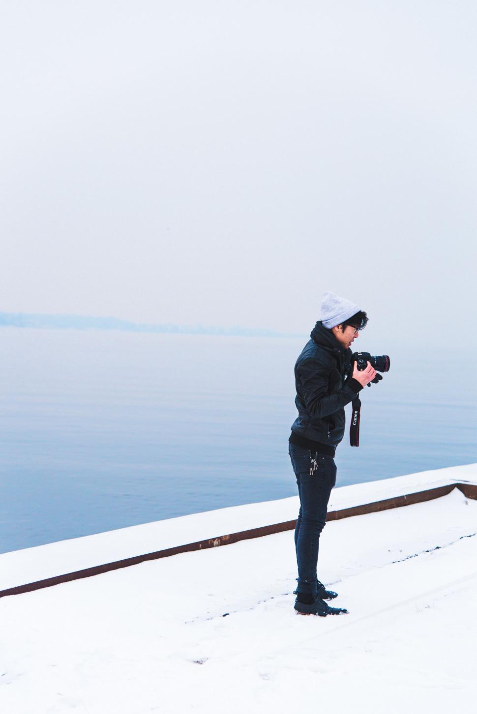 Free Image of Man Standing on Top of Snow Covered Slope 
