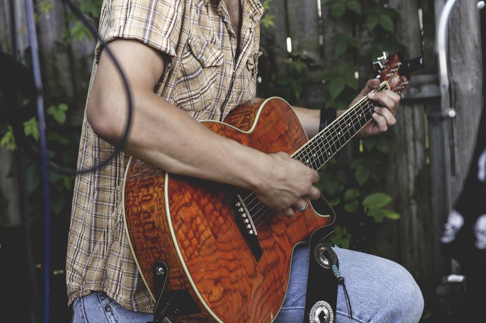 Free Image of Man Playing Guitar in Front of Microphone 