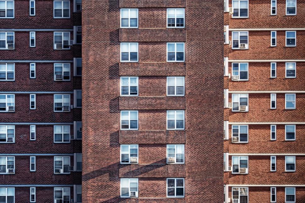 Free Image of Tall Brick Building Next to Another Tall Brick Building 