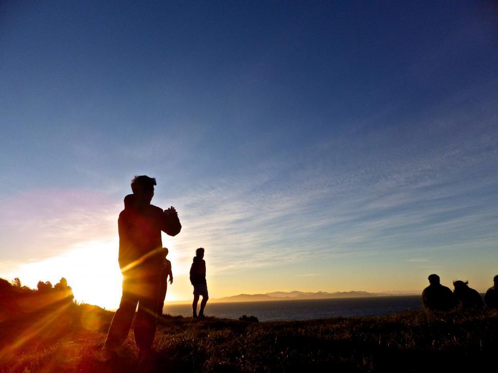 Free Image of Group of People Standing on Top of a Hill 