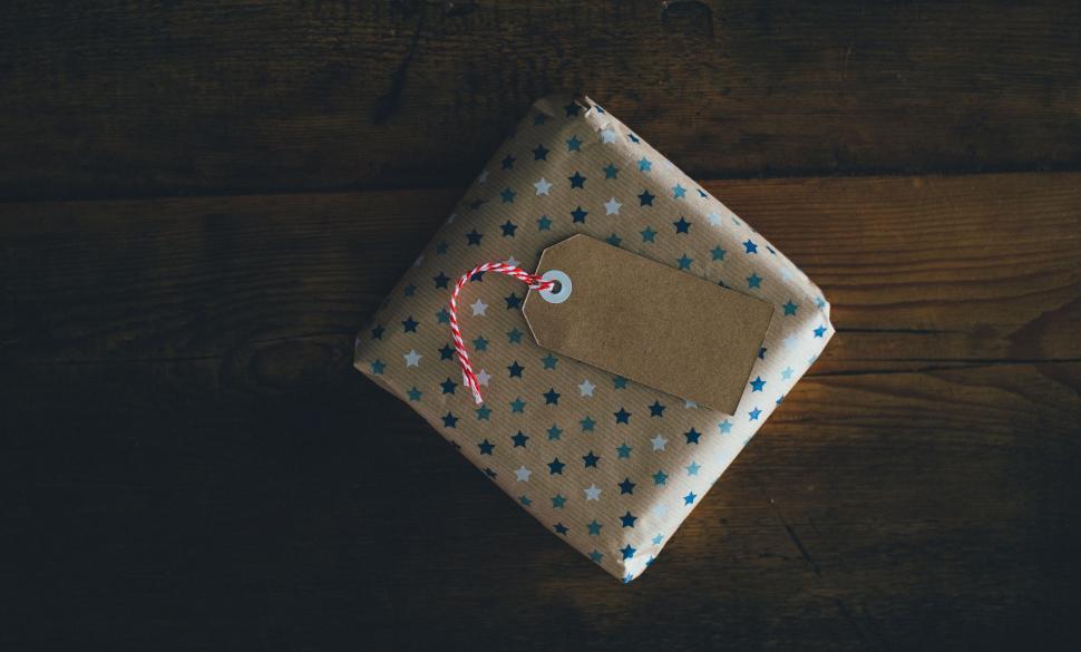 Free Image of Package With Tag on Wooden Table 