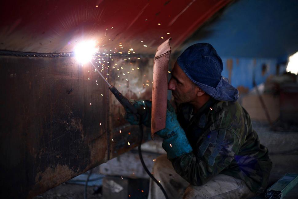 Free Image of Man Welding Metal Piece 