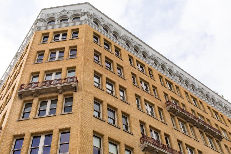 Free Image of Tall Yellow Building With Many Windows and Balconies 