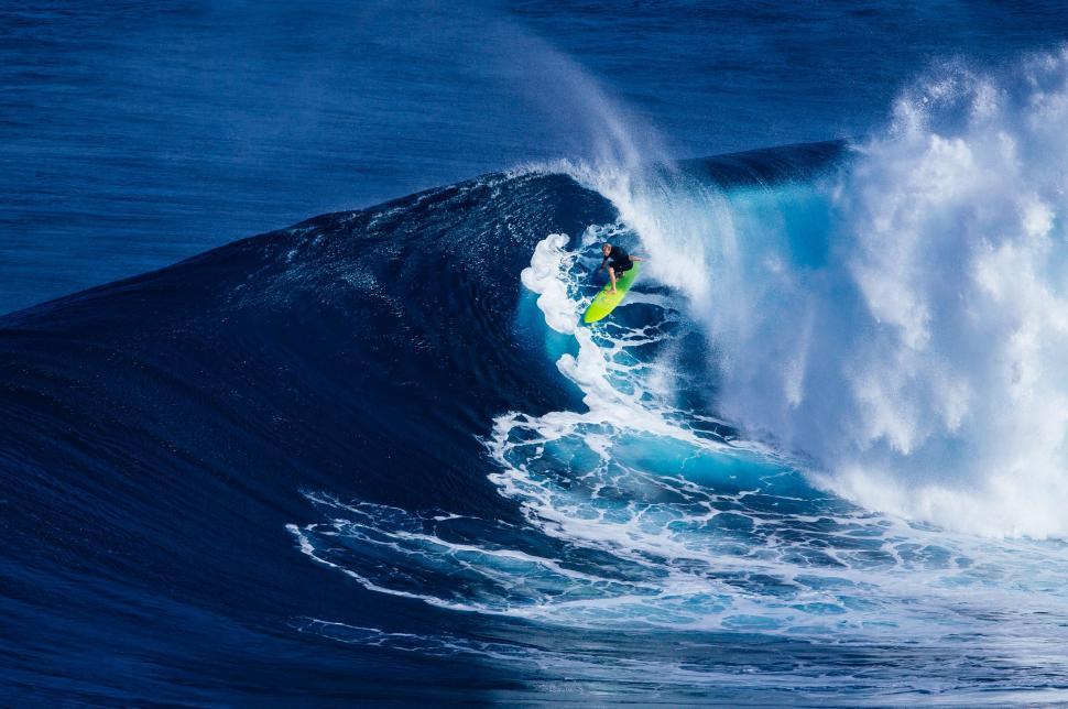 Free Image of Man Riding Wave on Surfboard 