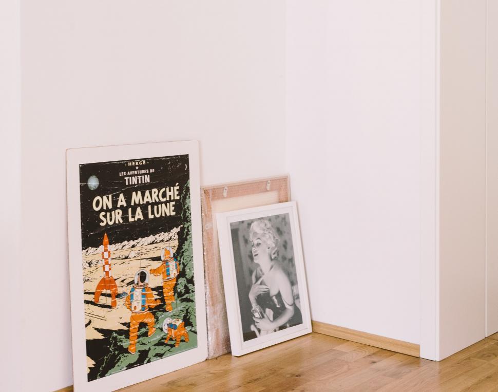 Free Image of Two Pictures Resting on Wooden Floor 