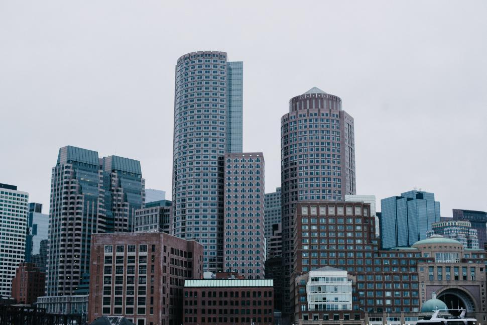 Free Image of Boat Sailing in Water With Large City Skyline 