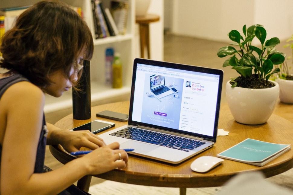 Free Image of Woman Sitting in Front of Laptop Computer 