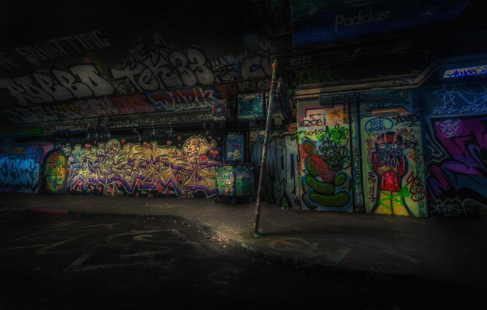 Free Image of Wall Covered in Graffiti in Dark Room 