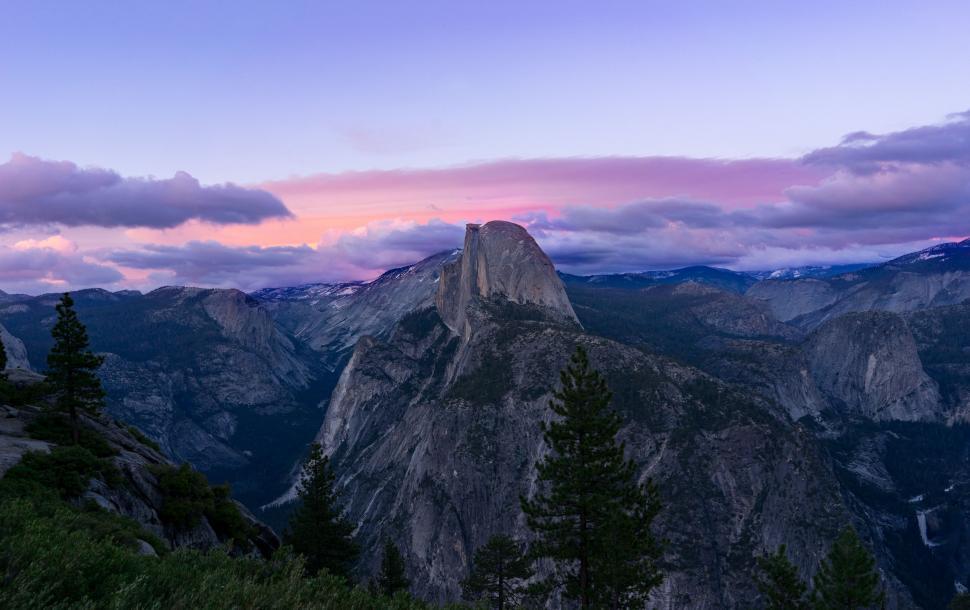 Free Image of Majestic Mountain Range Silhouetted Against a Setting Sun 