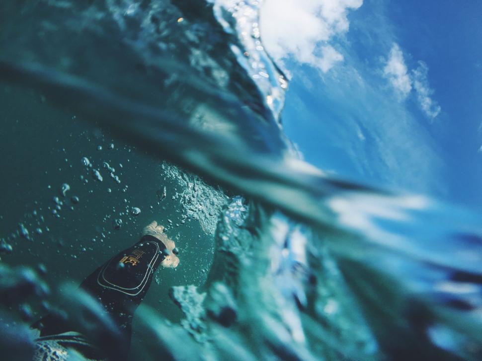 Free Image of Man Riding Wave on Surfboard 