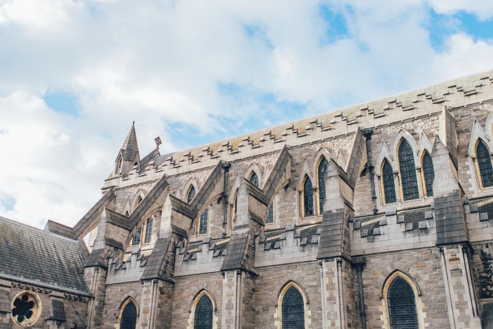 Free Image of Large Stone Building With Clock on Side 